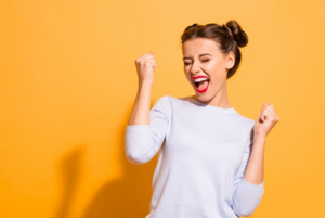 Woman smiling and dancing in excitement